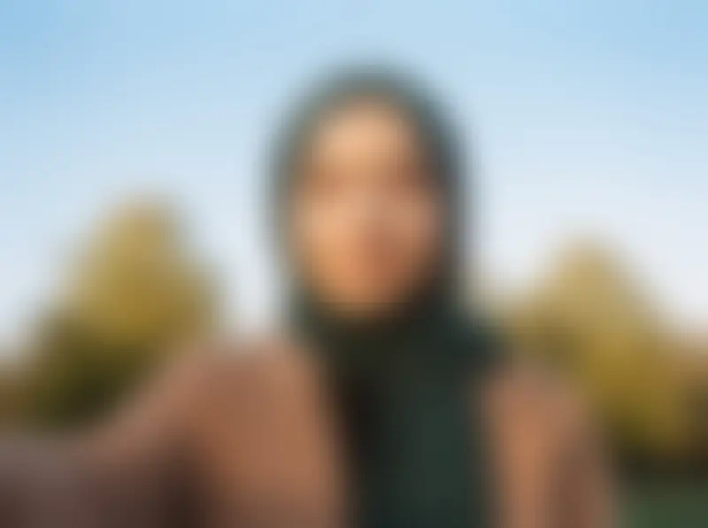 A blurred profile photo of a Muslim woman in a green headscarf, showing how Habiboo hides photos